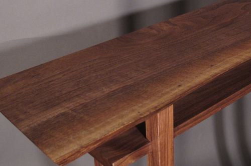 Mokuzai Furniture's Classic table with a live edge table top, pictured in walnut.